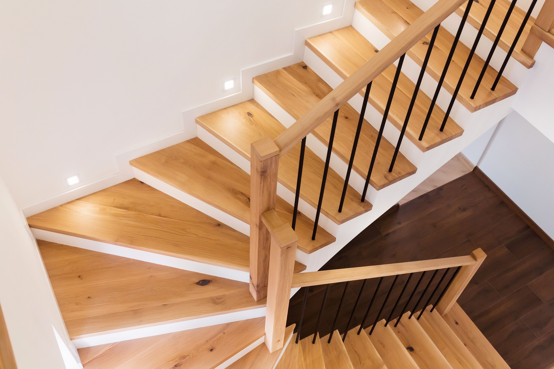 Wood staircase inside contemporary white modern house.